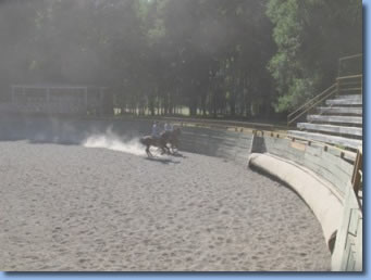 2 riders practicing rodeo moves in the media luna on a rodeo clinic with Antilco