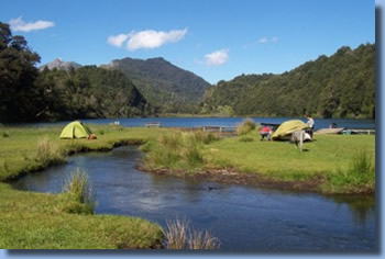 Tents on lakeshore on a horseback trail ride in NP Huequehue, Chile